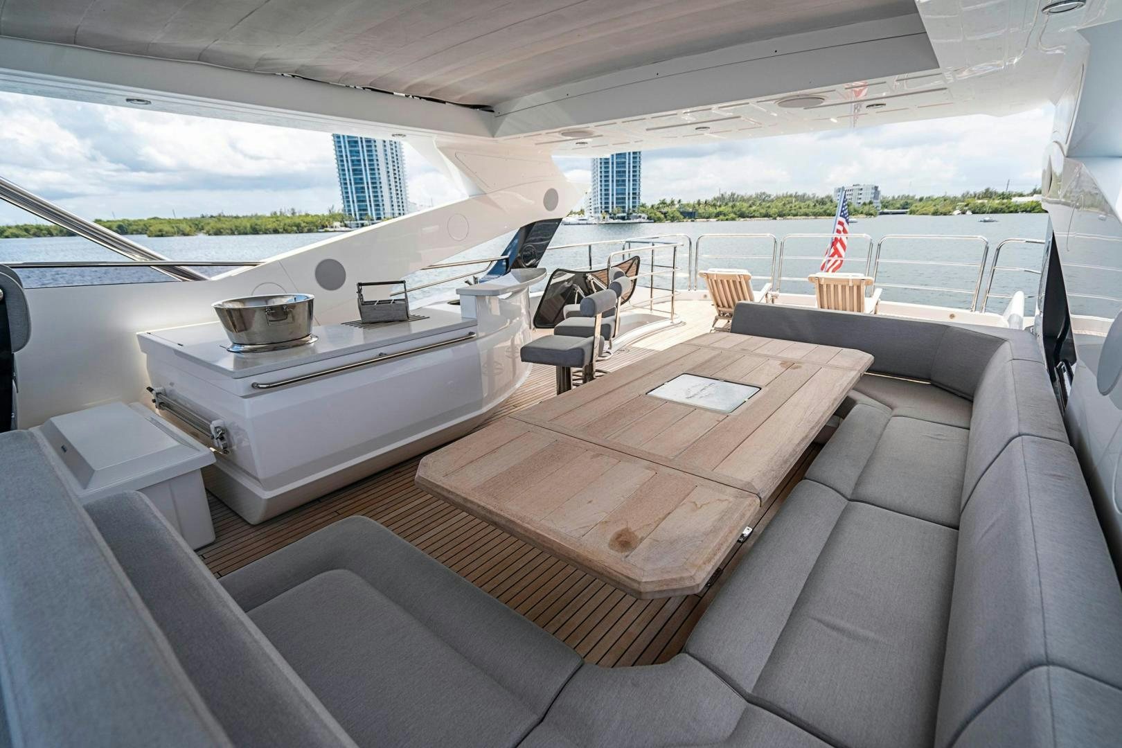 a large white lounge chair in a room with a large white table and chairs and a large window aboard QUANTUM Yacht for Sale