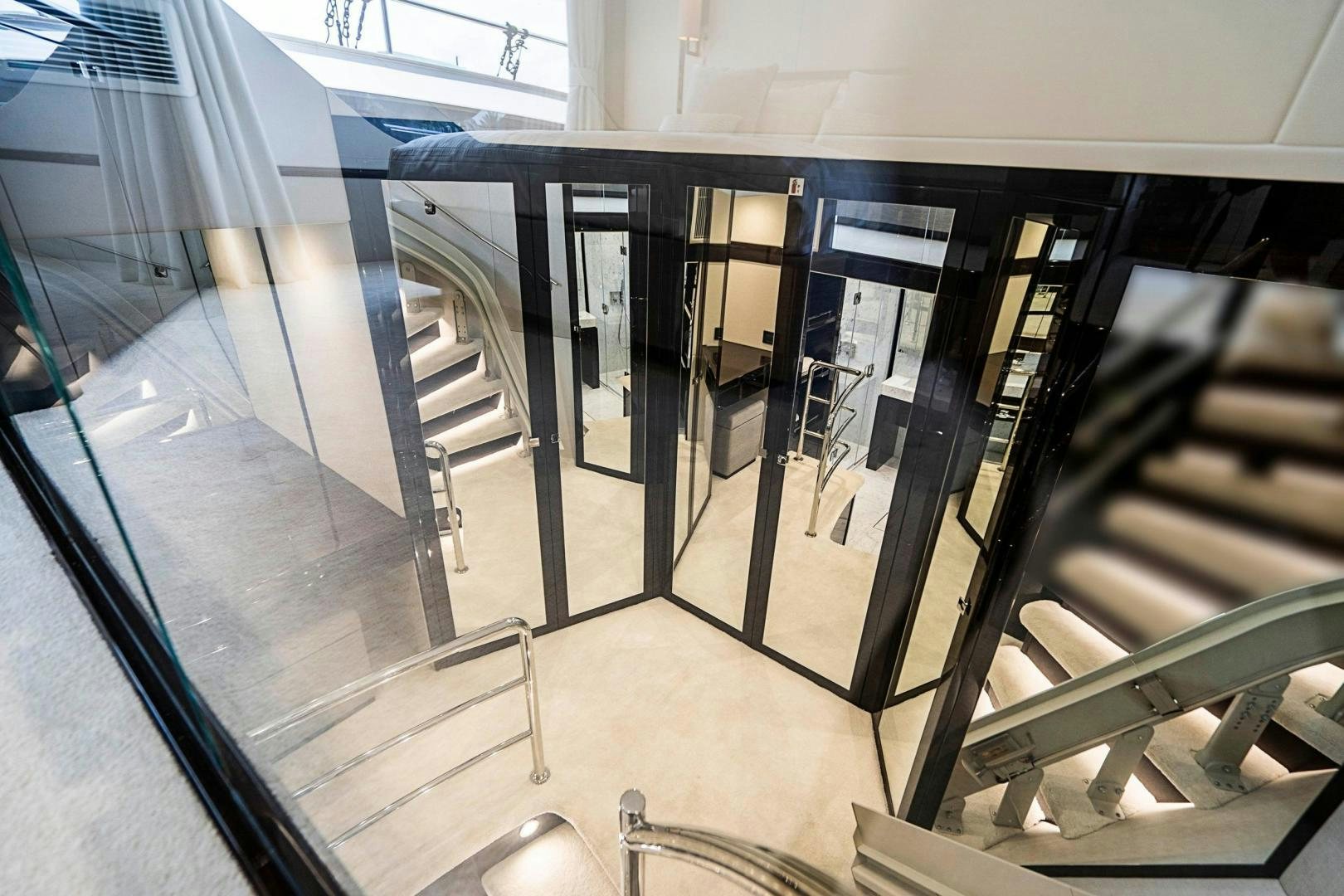 a hallway with glass doors aboard QUANTUM Yacht for Sale