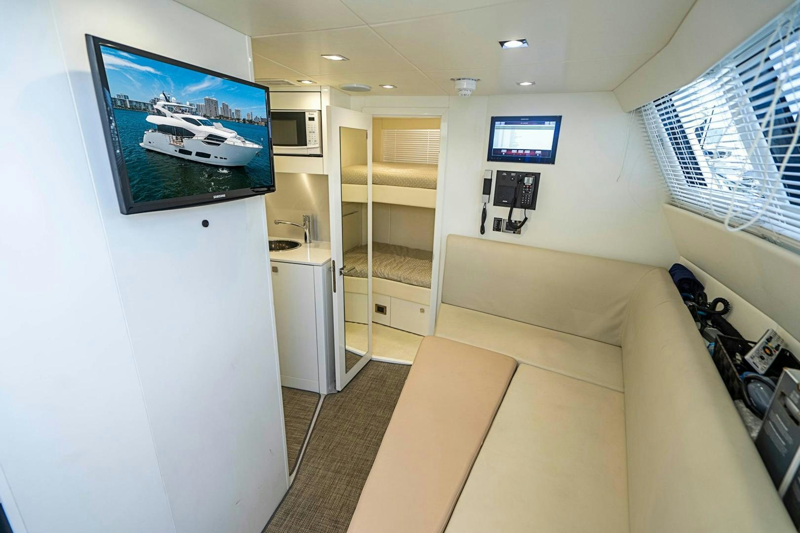 a room with a tv and a couch aboard QUANTUM Yacht for Sale