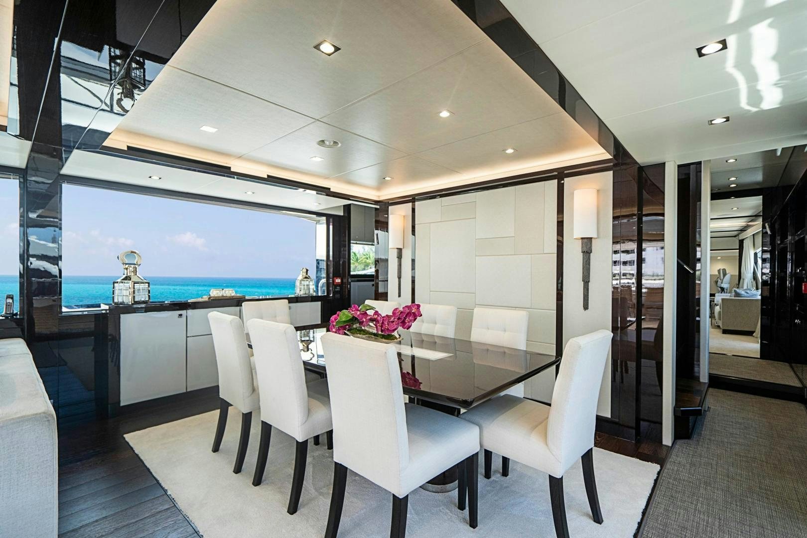 a room with a table chairs and a window aboard QUANTUM Yacht for Sale