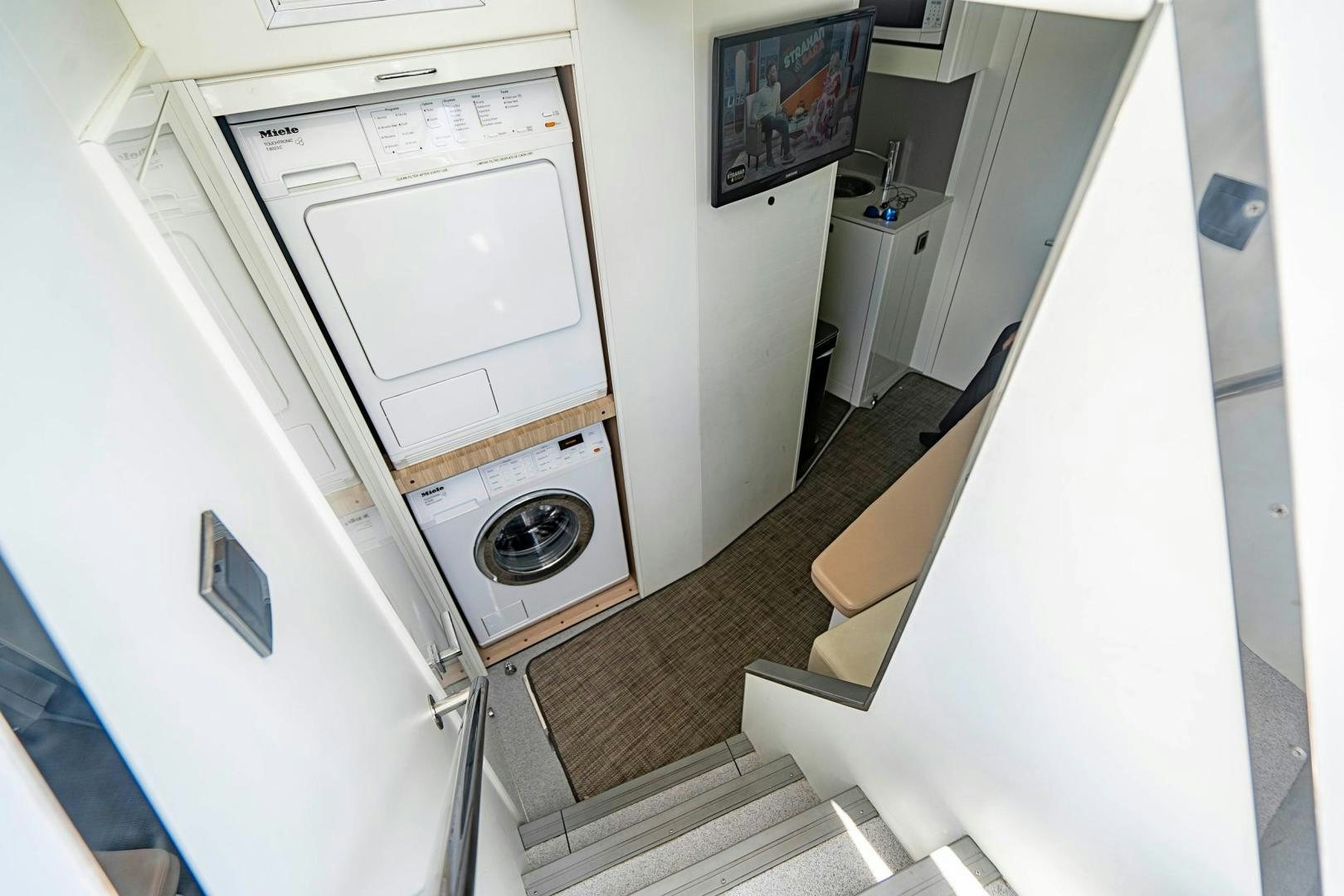 a washing machine in a room aboard QUANTUM Yacht for Sale