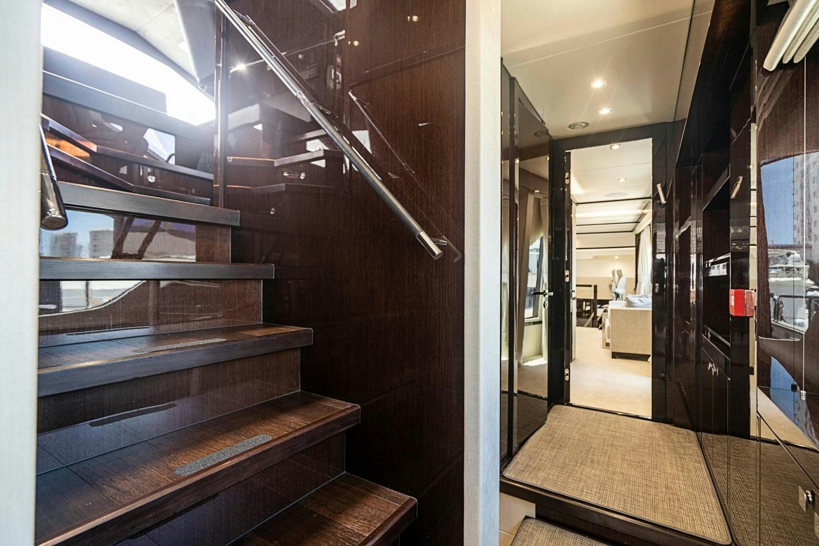 a wood staircase in a building aboard QUANTUM Yacht for Sale