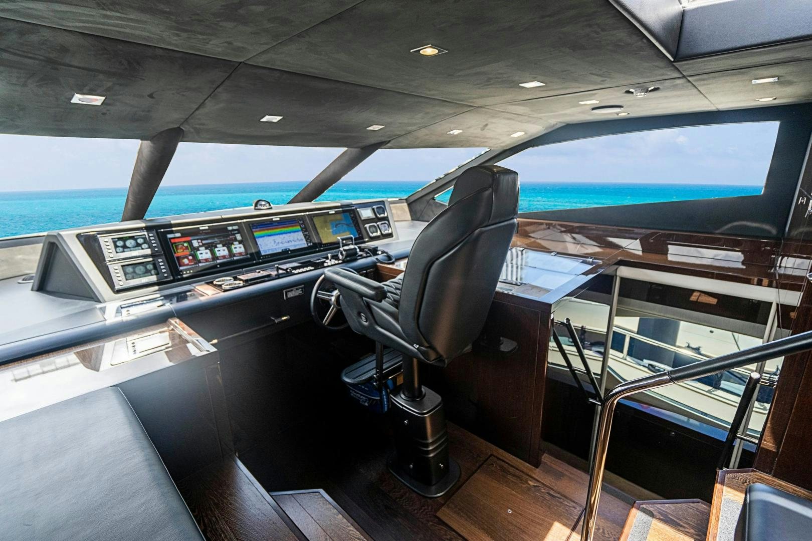 a black leather chair in a vehicle aboard QUANTUM Yacht for Sale