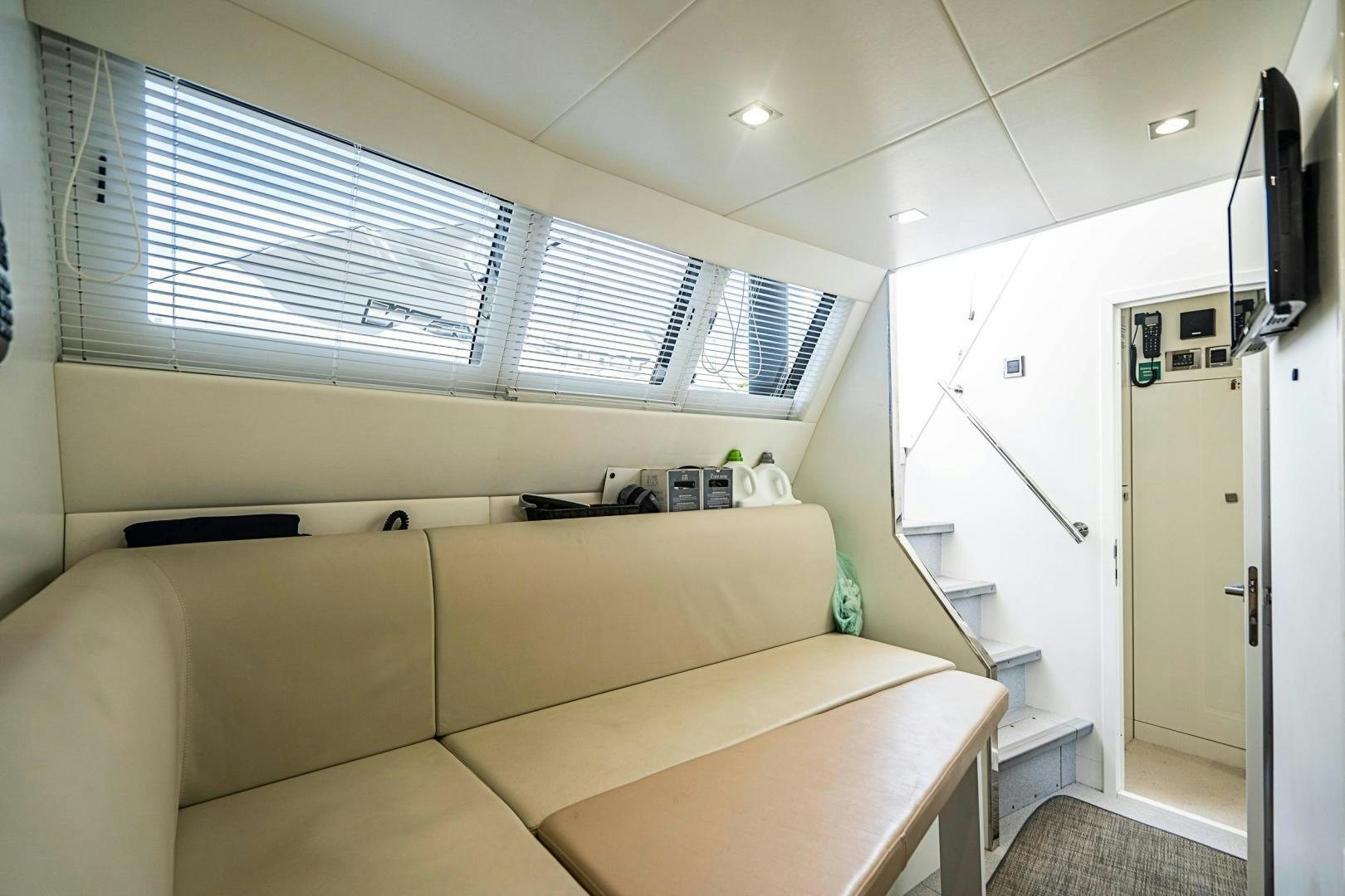 a room with a couch and a television aboard QUANTUM Yacht for Sale