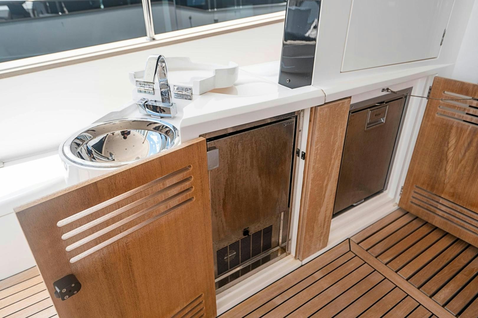 a kitchen with wooden cabinets aboard QUANTUM Yacht for Sale