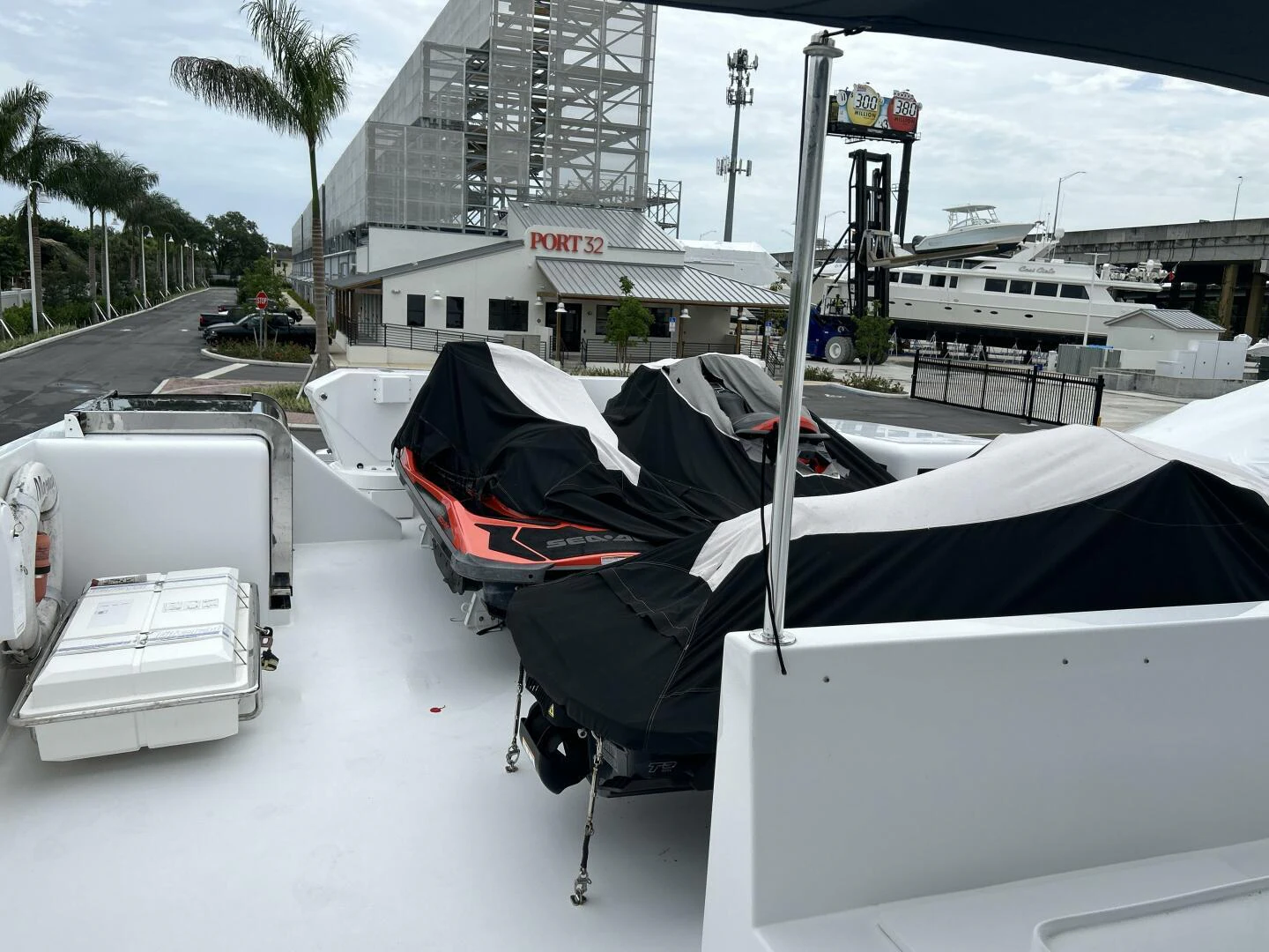 a white vehicle with a black hood parked on a street with buildings and trees and a car and aboard MARGAUX Yacht for Sale
