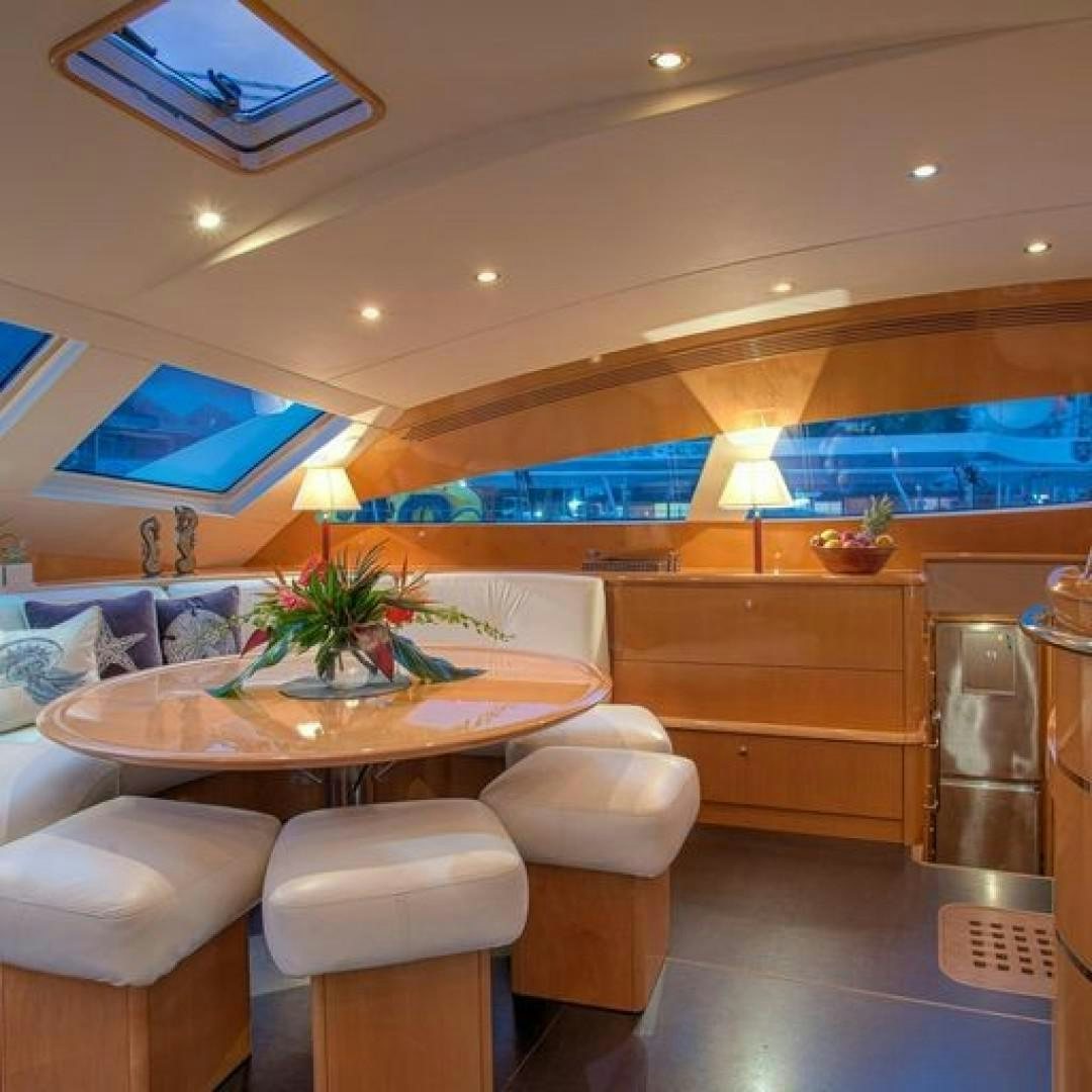 a room with a table and chairs aboard MATAU Yacht for Sale