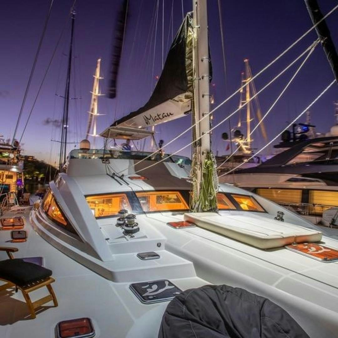 a boat parked in a harbor aboard MATAU Yacht for Sale