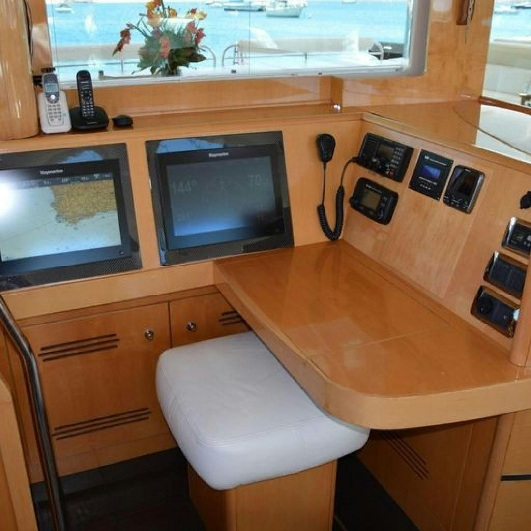 a desk with a television and a chair aboard MATAU Yacht for Sale