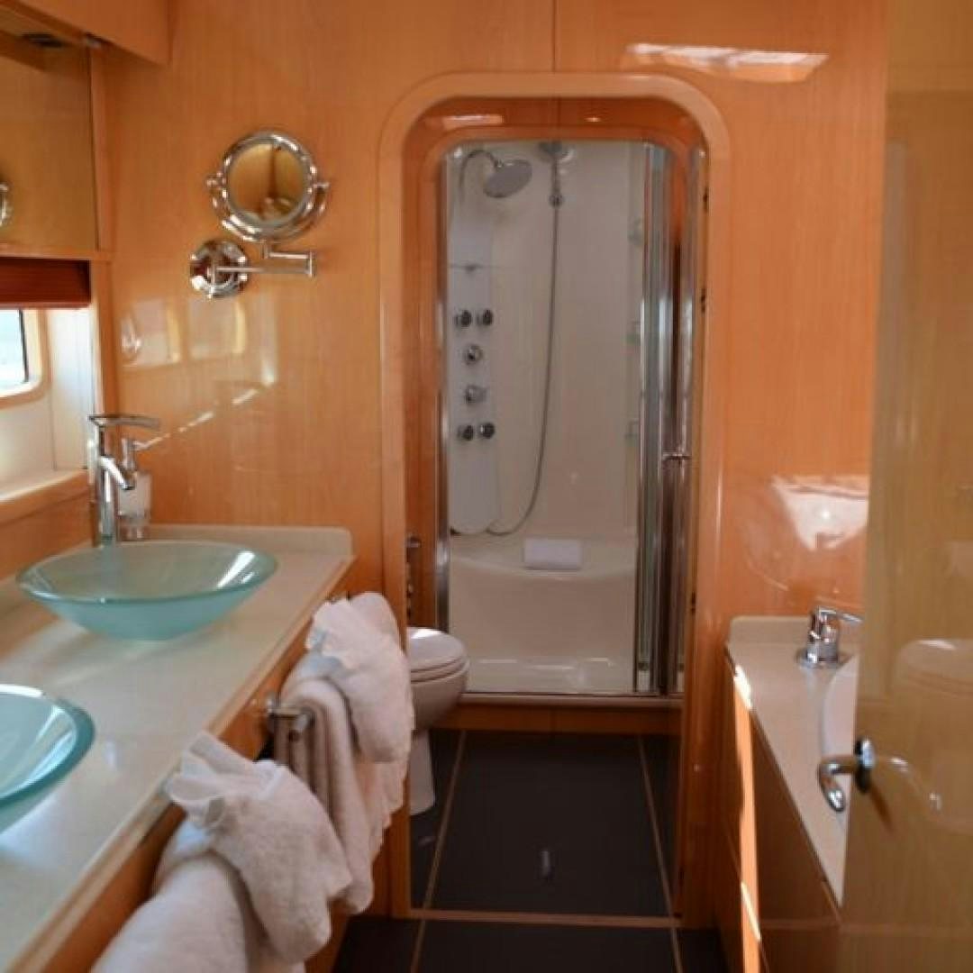 a bathroom with a sink and a mirror aboard MATAU Yacht for Sale
