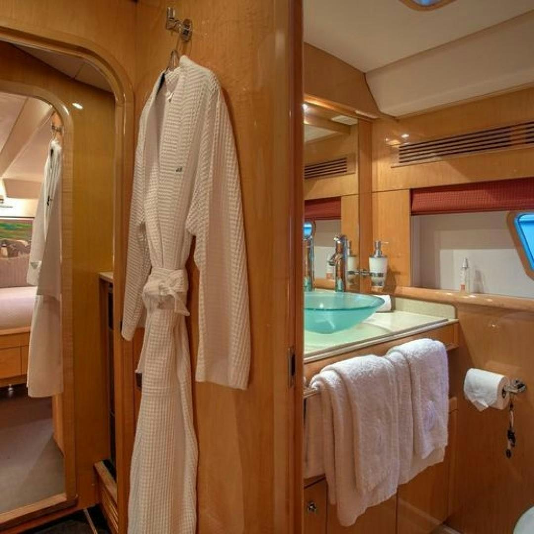 a bathroom with a sink and towels aboard MATAU Yacht for Sale