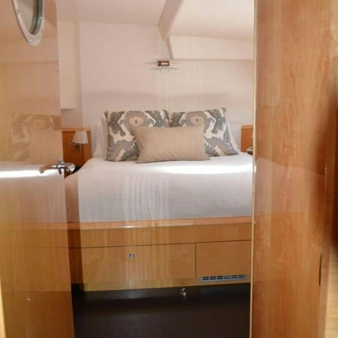 a bed with a white pillow aboard MATAU Yacht for Sale