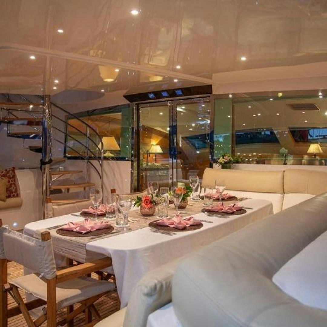 a room with tables and chairs aboard MATAU Yacht for Sale