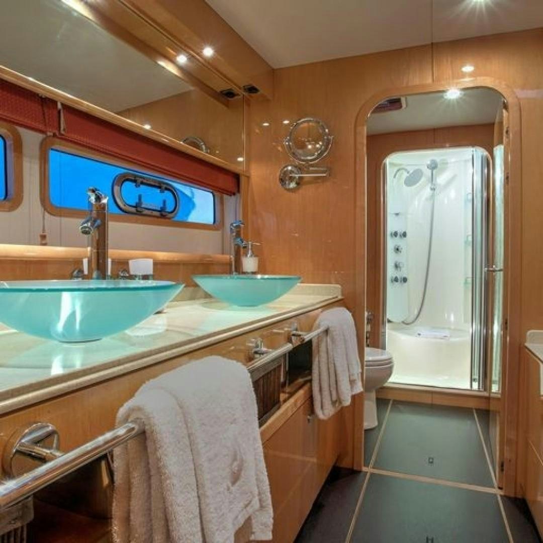 a bathroom with a sink and a mirror aboard MATAU Yacht for Sale