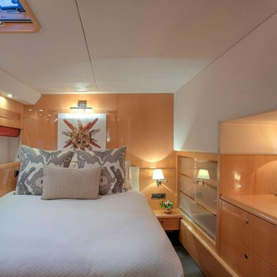 a bed with a white bed spread aboard MATAU Yacht for Sale