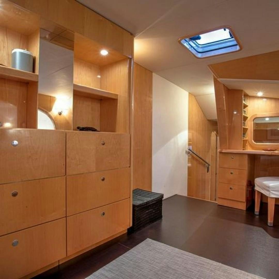 a kitchen with wooden cabinets aboard MATAU Yacht for Sale