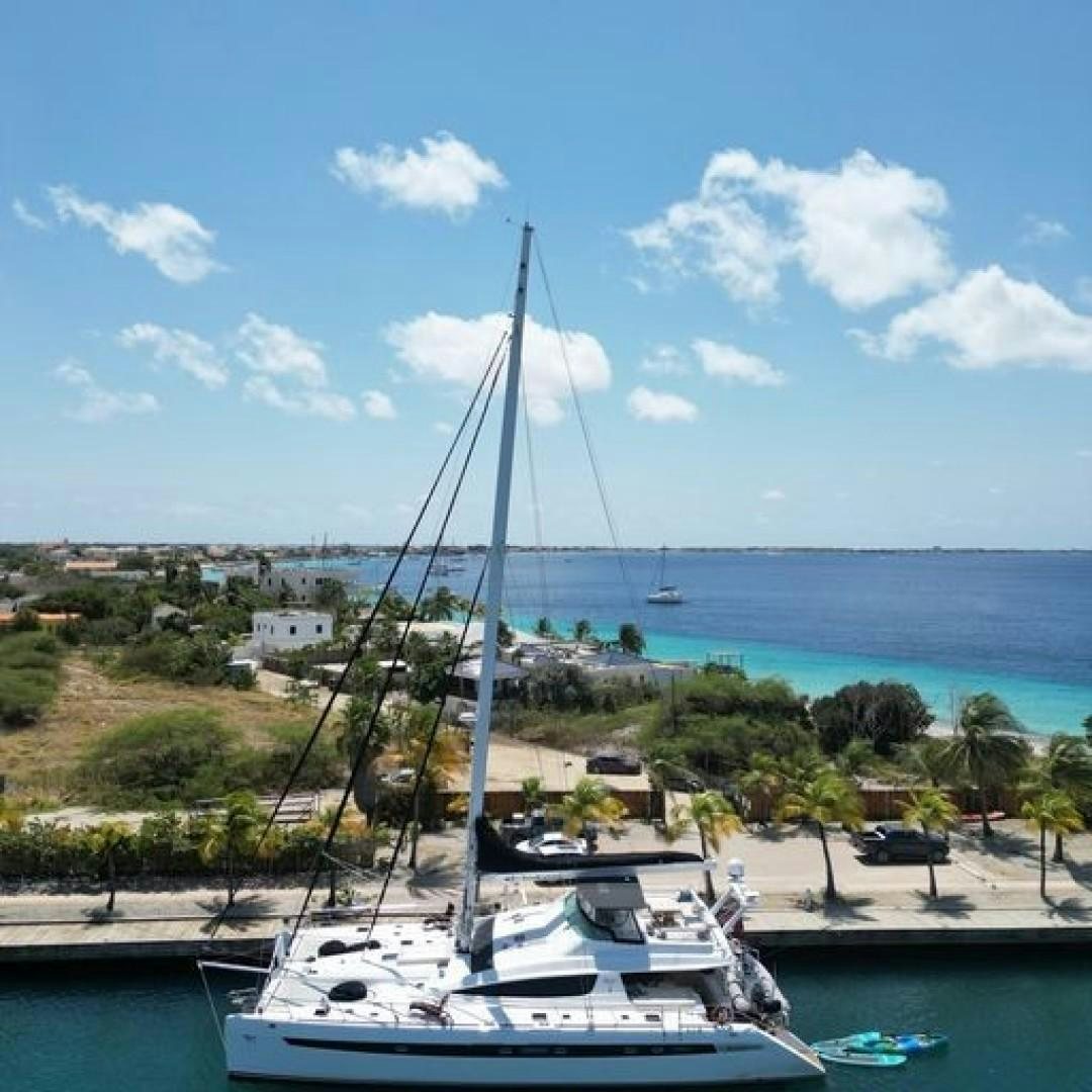 a sailboat in a harbor aboard MATAU Yacht for Sale