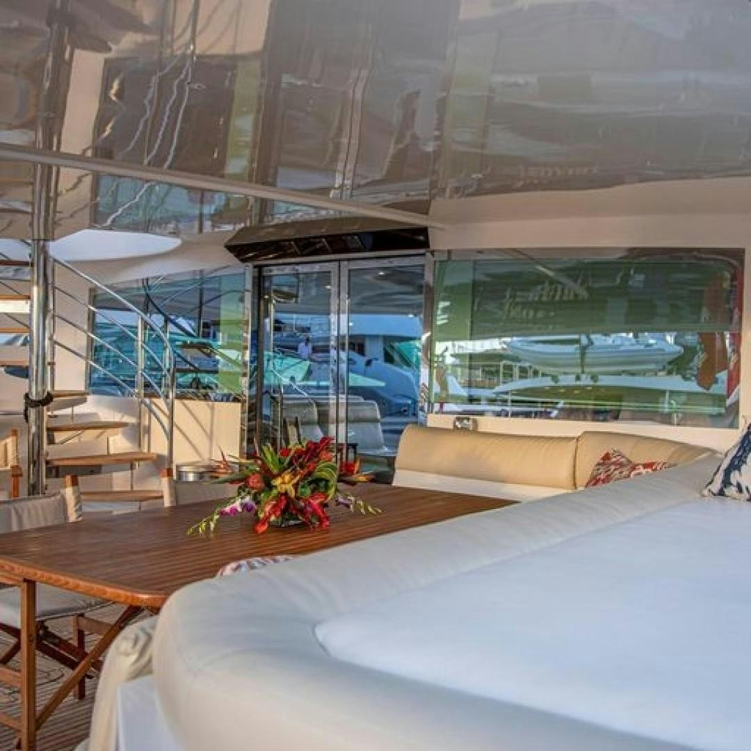 a room with a bed and a table and a window aboard MATAU Yacht for Sale