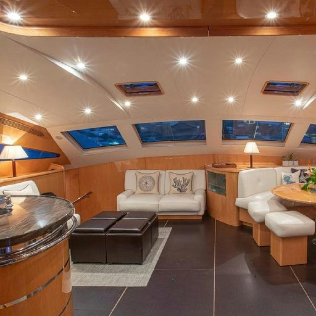 a room with a couch and a table aboard MATAU Yacht for Sale