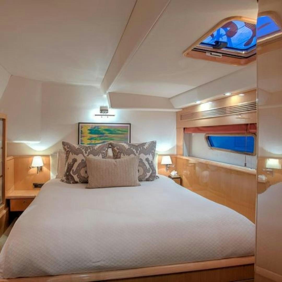 a bed with a pillow and a television on it aboard MATAU Yacht for Sale