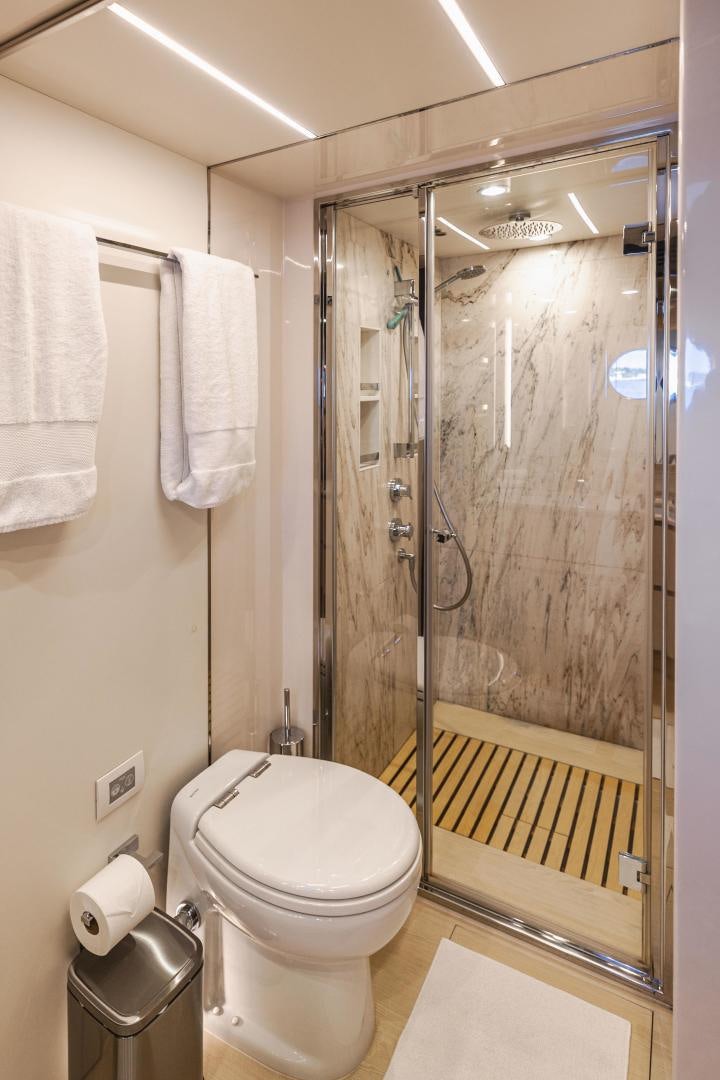 a bathroom with a glass shower aboard MIREYA Yacht for Sale