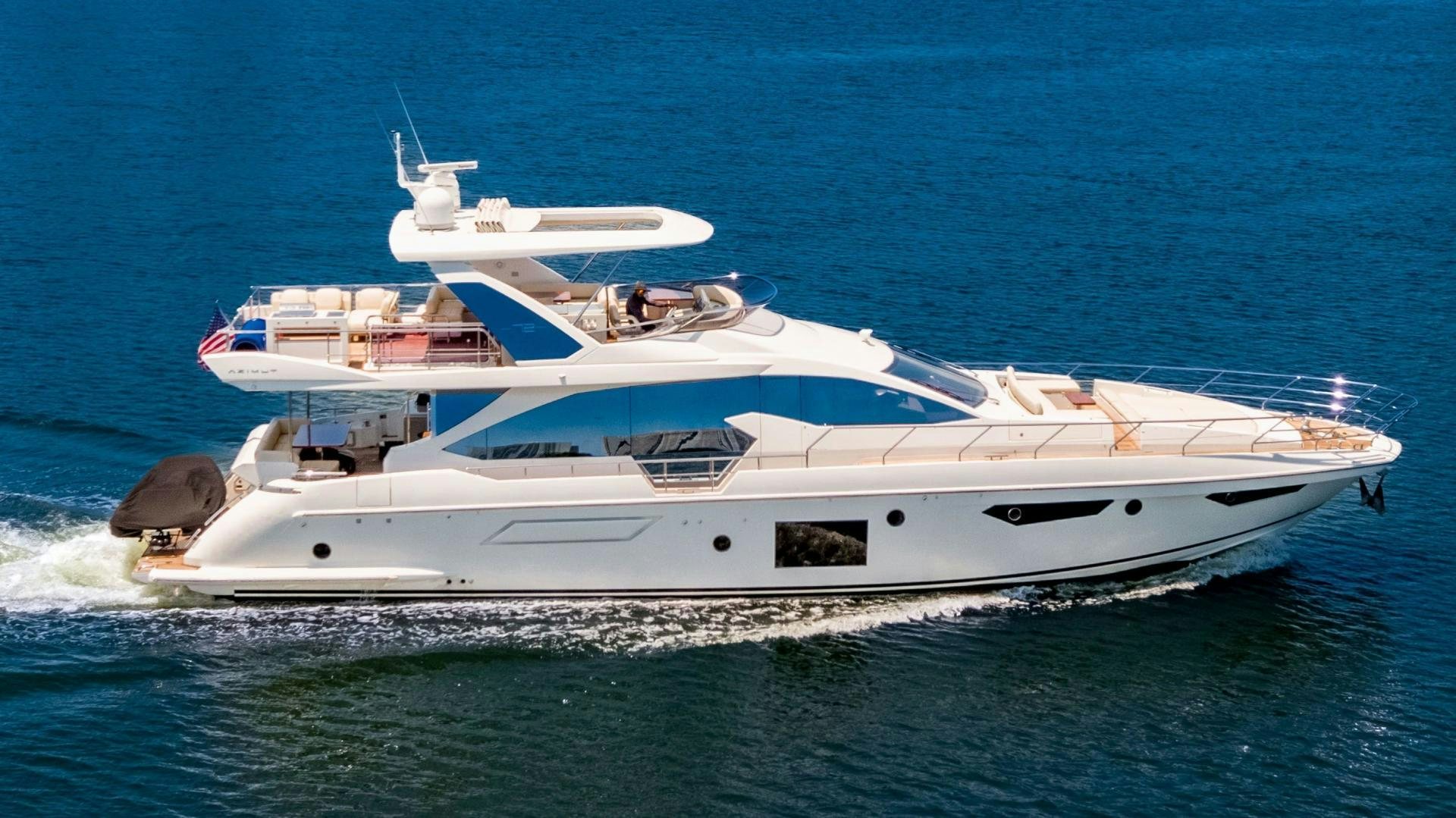 a white yacht with a white boat on the water aboard MIREYA Yacht for Sale