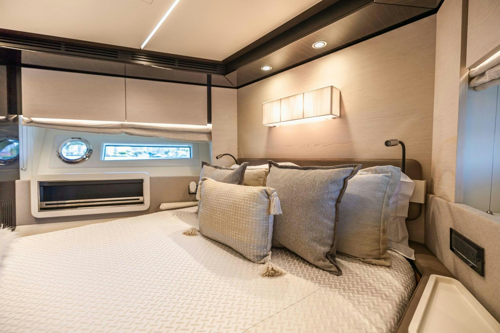 a bed with pillows and a television aboard MIREYA Yacht for Sale