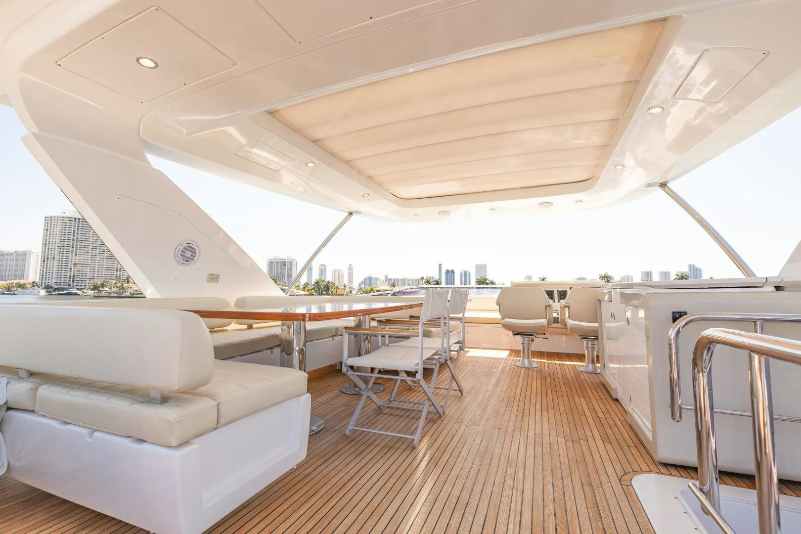 a room with a wood floor and white furniture aboard MIREYA Yacht for Sale