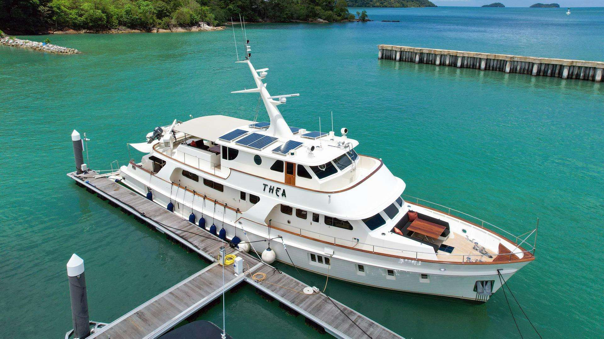 a white boat on a dock aboard THEA Yacht for Sale