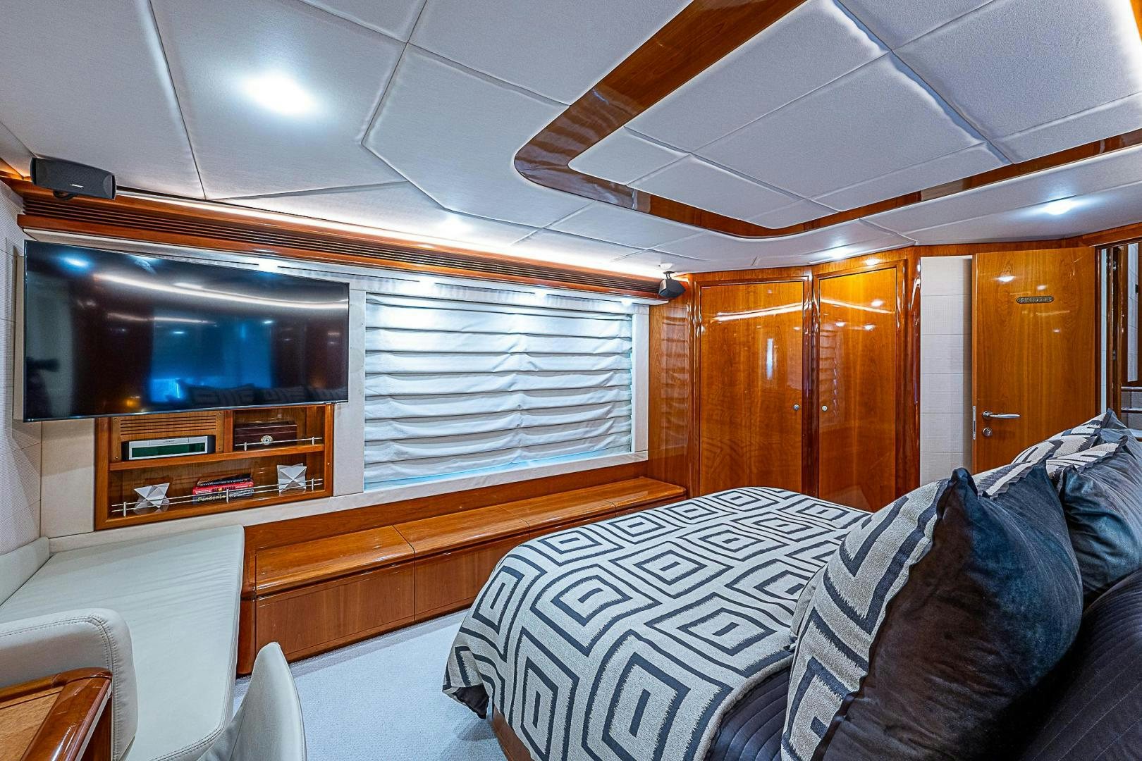 a room with a couch and a television aboard LA BELLA VITA Yacht for Sale