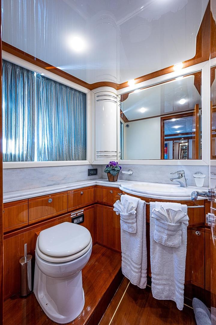 a bathroom with a toilet and a sink aboard LA BELLA VITA Yacht for Sale
