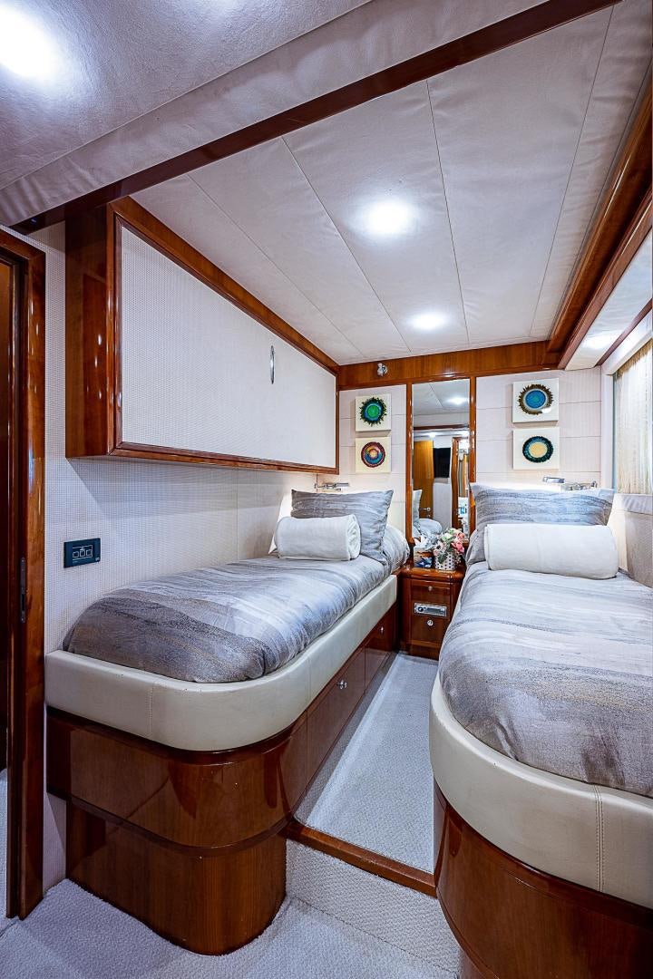 a bedroom with two beds aboard LA BELLA VITA Yacht for Sale