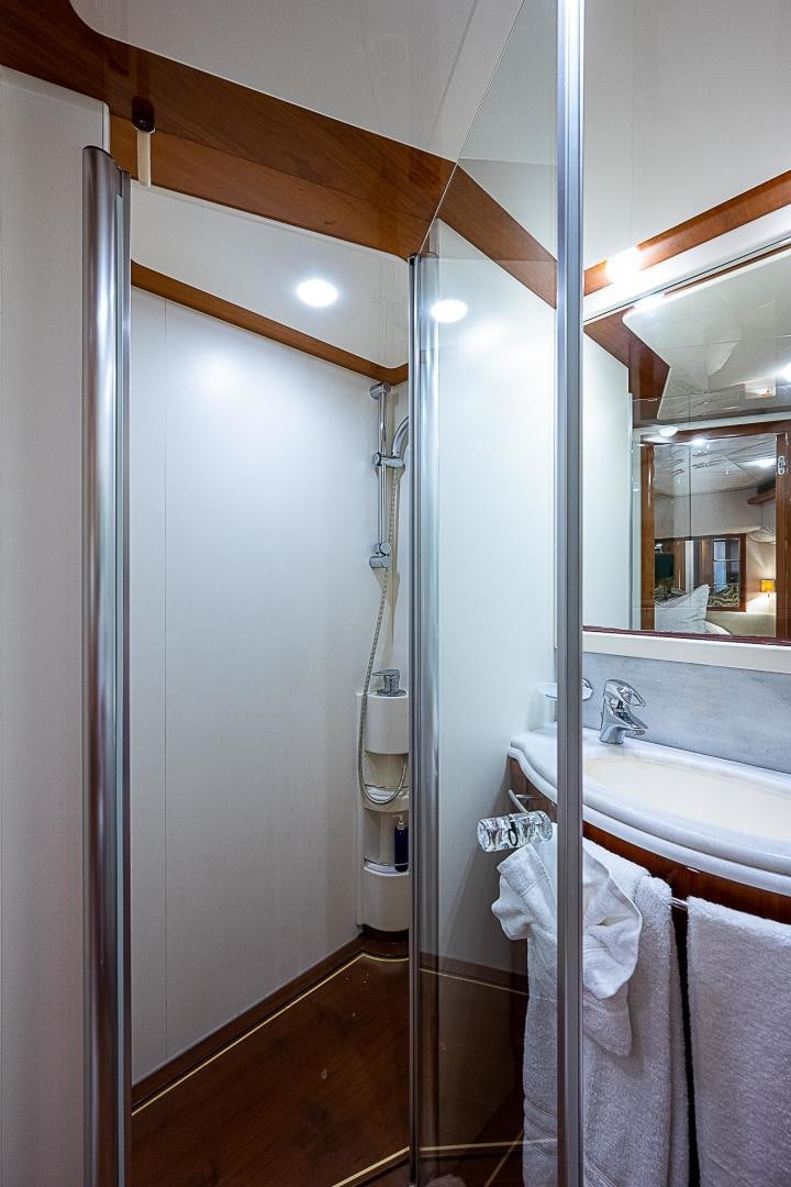 a bathroom with a shower unit and sink aboard LA BELLA VITA Yacht for Sale