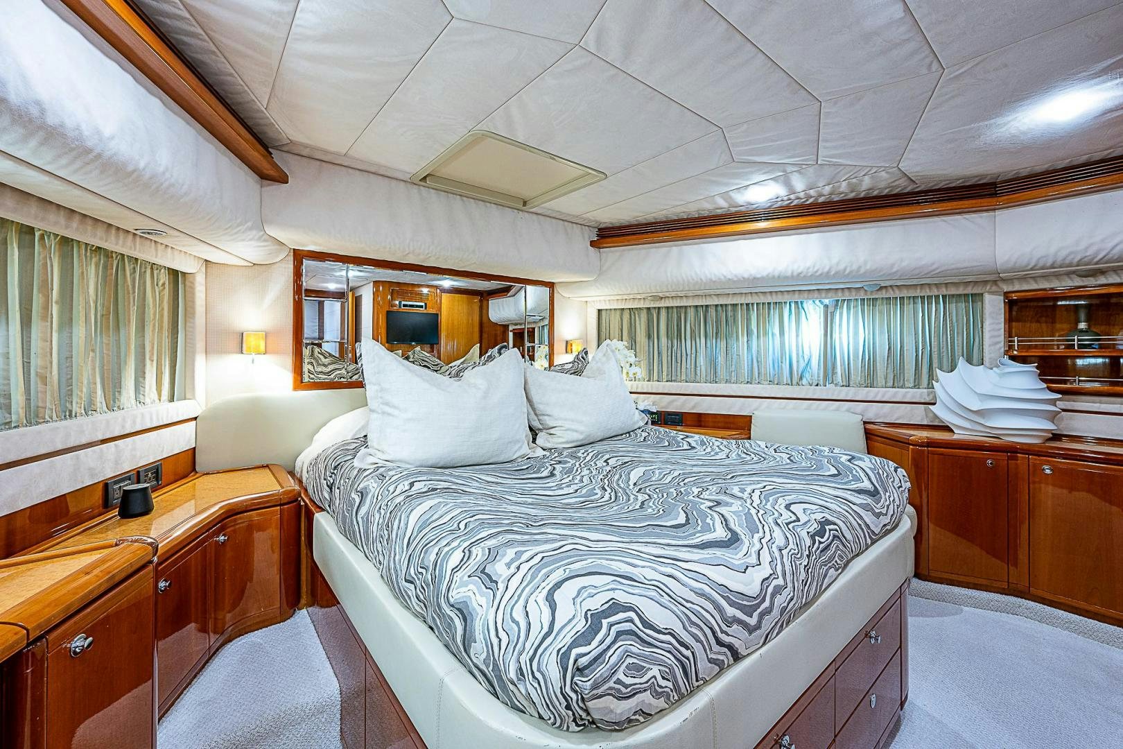 a bedroom with a bed and a dresser aboard LA BELLA VITA Yacht for Sale
