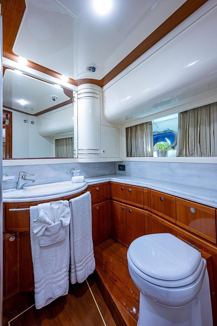 a bathroom with a toilet and a sink aboard LA BELLA VITA Yacht for Sale