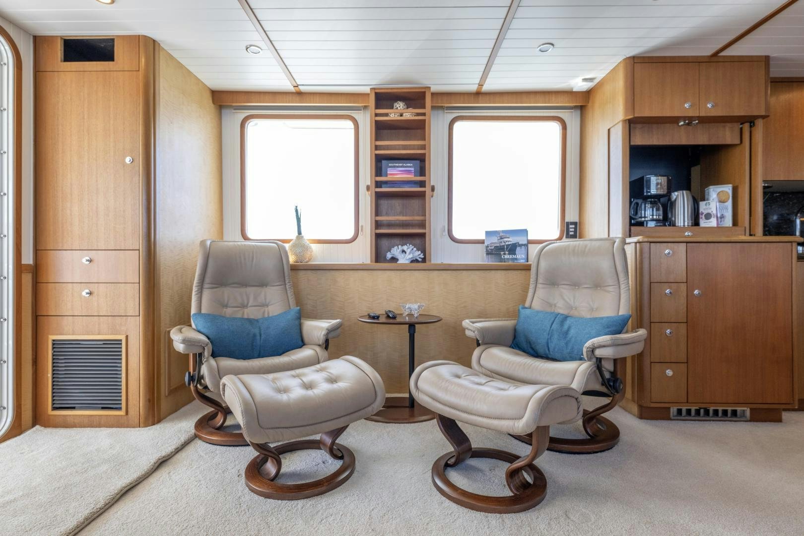 a room with a couple of chairs and a table aboard CHEEMAUN Yacht for Sale