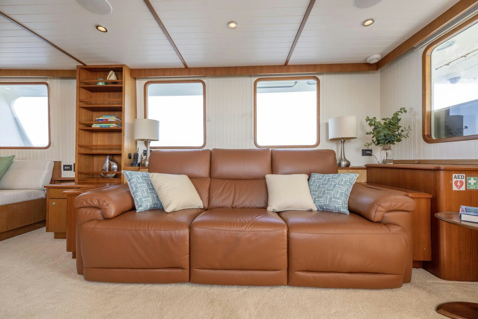 a living room with a brown couch aboard CHEEMAUN Yacht for Sale