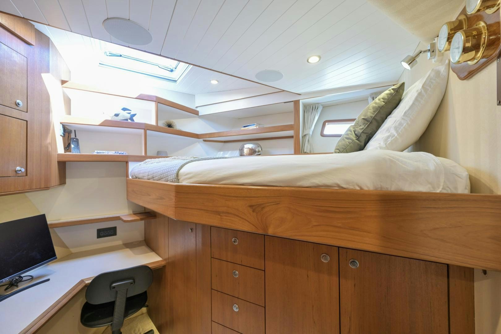 a bedroom with a bed and desk aboard CHEEMAUN Yacht for Sale