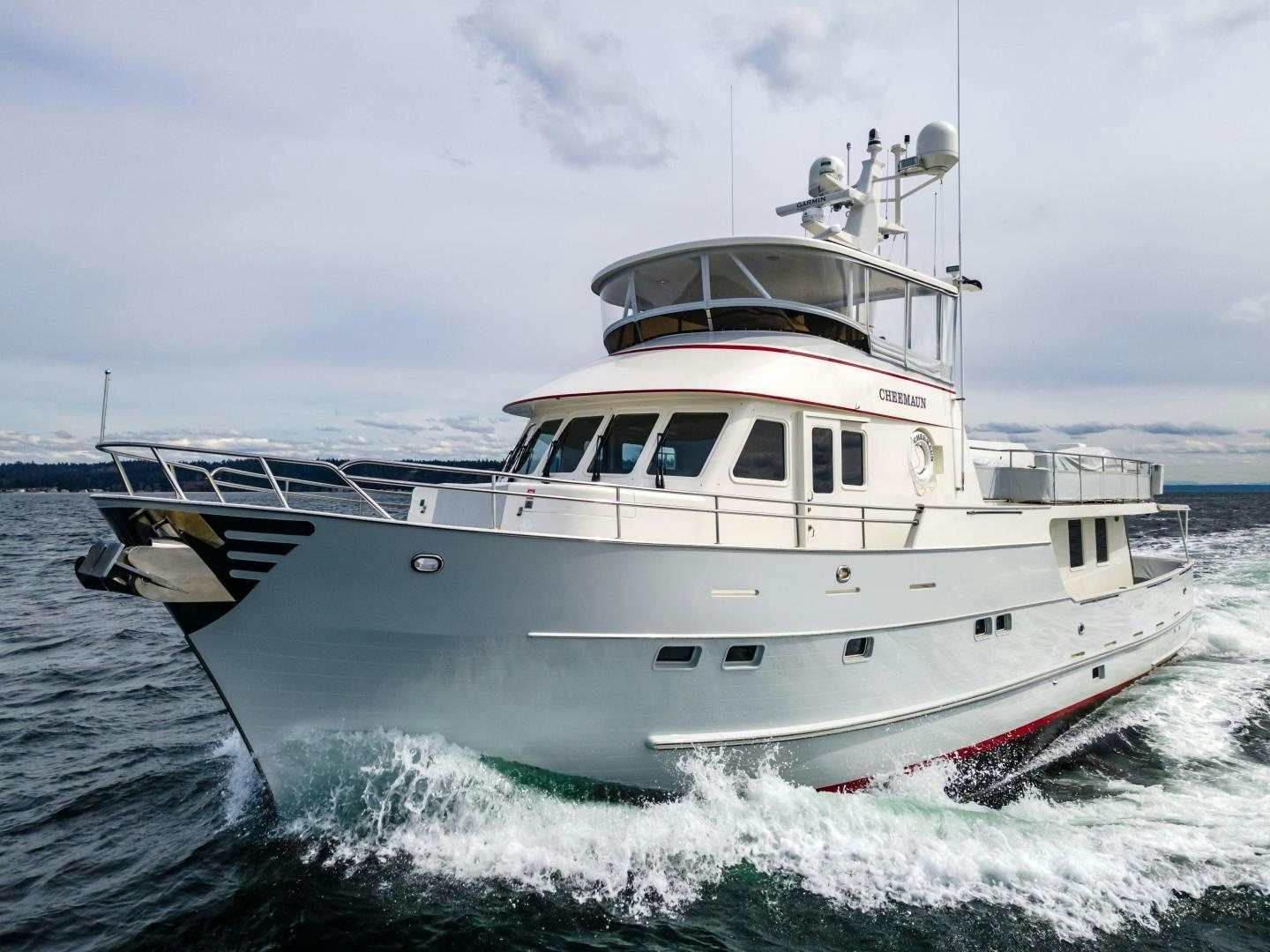 a white boat in the water aboard CHEEMAUN Yacht for Sale