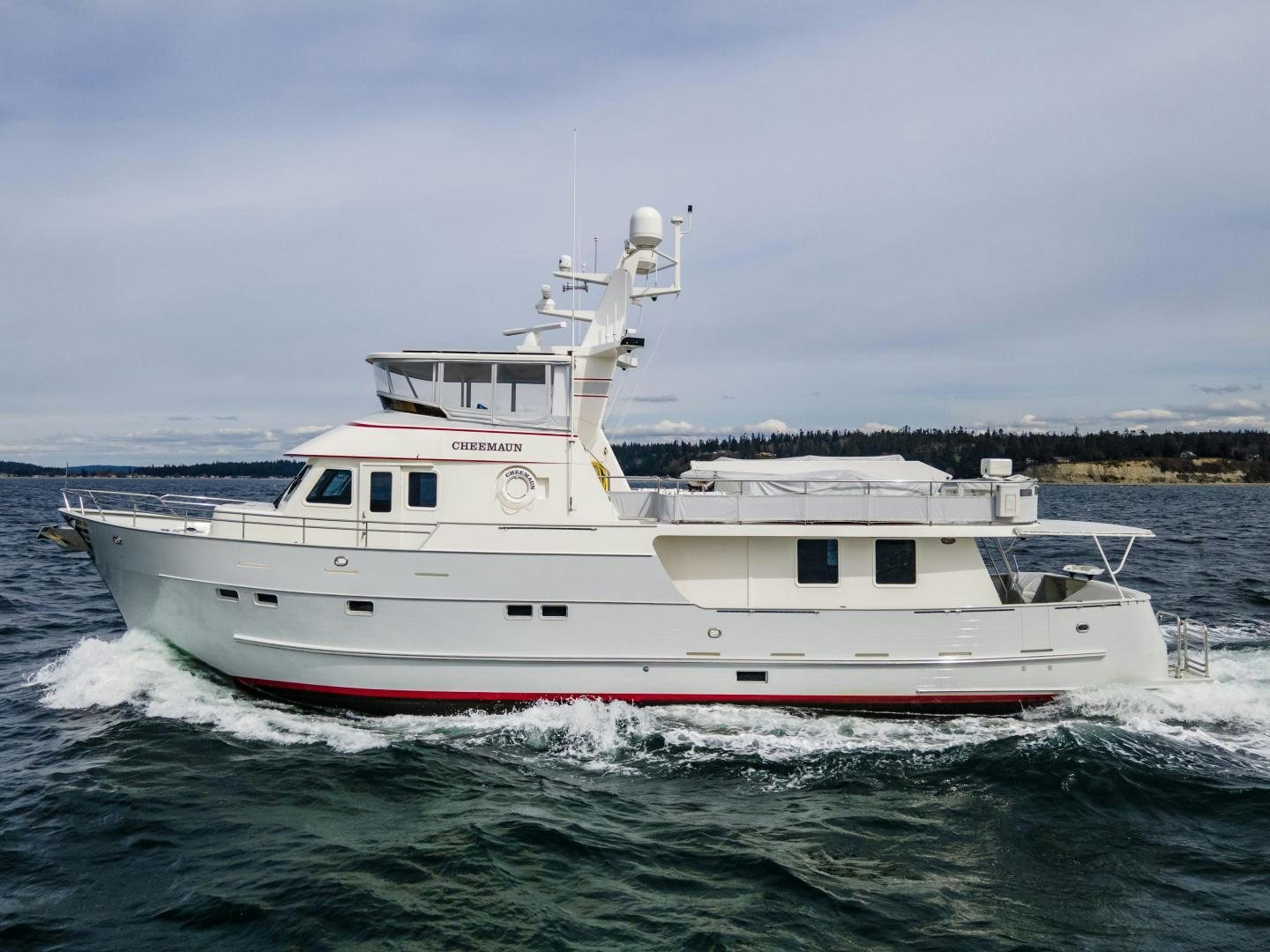 a white boat in the water aboard CHEEMAUN Yacht for Sale