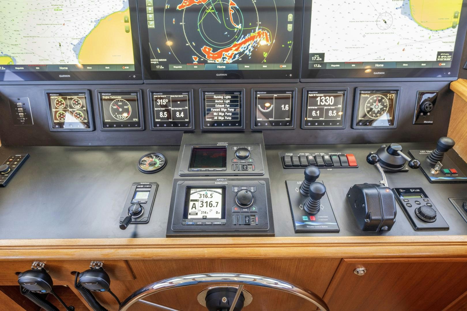 a control panel with a variety of buttons and dials aboard CHEEMAUN Yacht for Sale