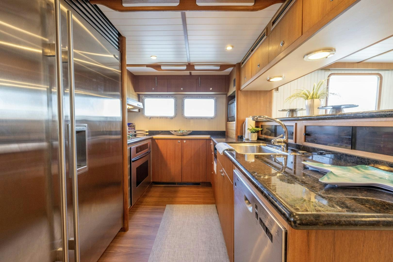a kitchen with a large refrigerator aboard CHEEMAUN Yacht for Sale