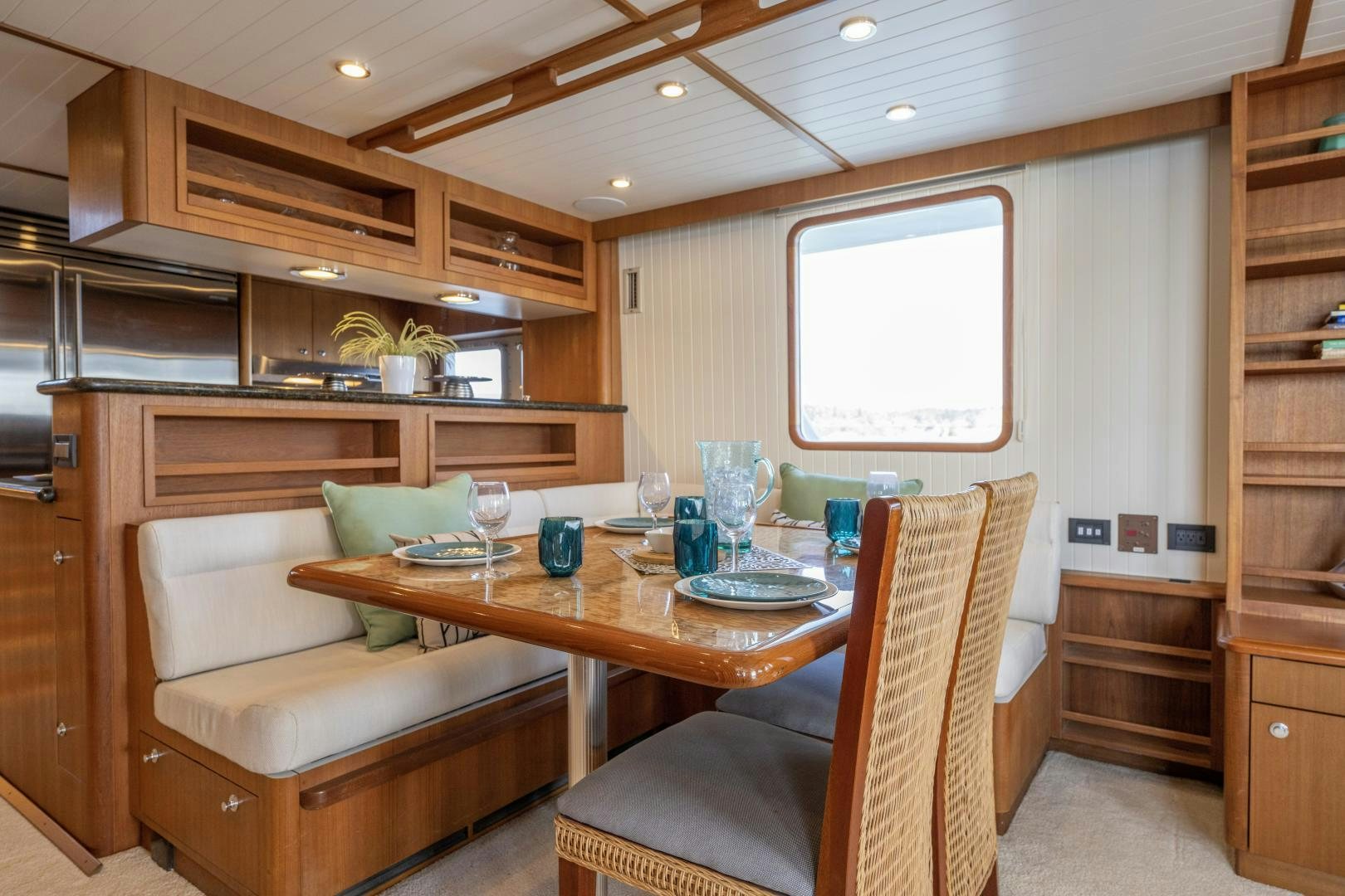 a kitchen with a table and chairs aboard CHEEMAUN Yacht for Sale