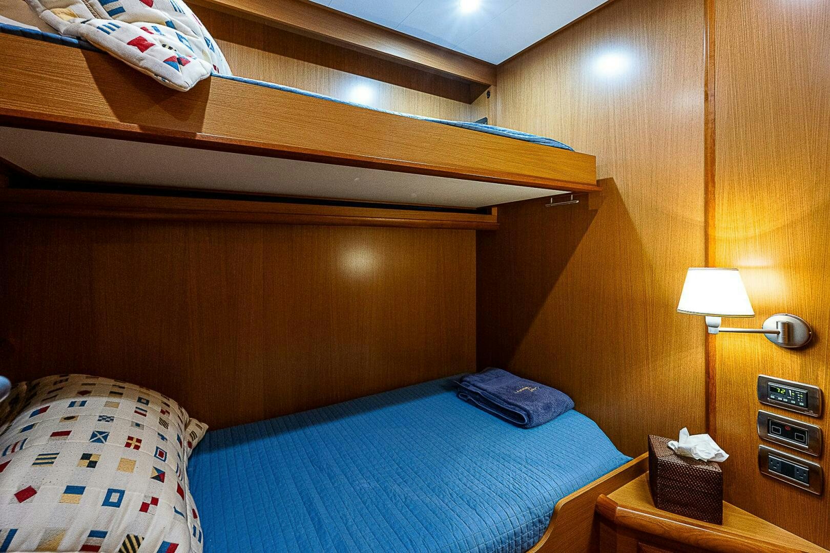 a bed with a blue comforter aboard KNOT NANNY'S Yacht for Sale