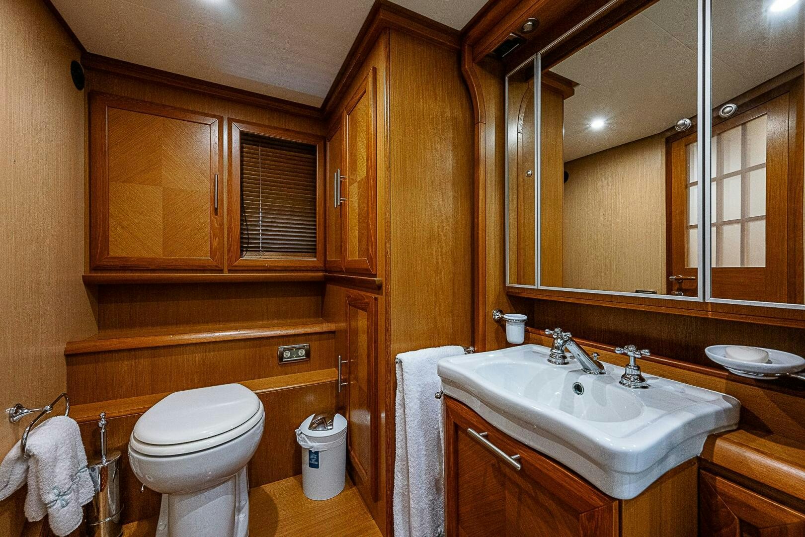 a bathroom with wooden cabinets aboard KNOT NANNY'S Yacht for Sale
