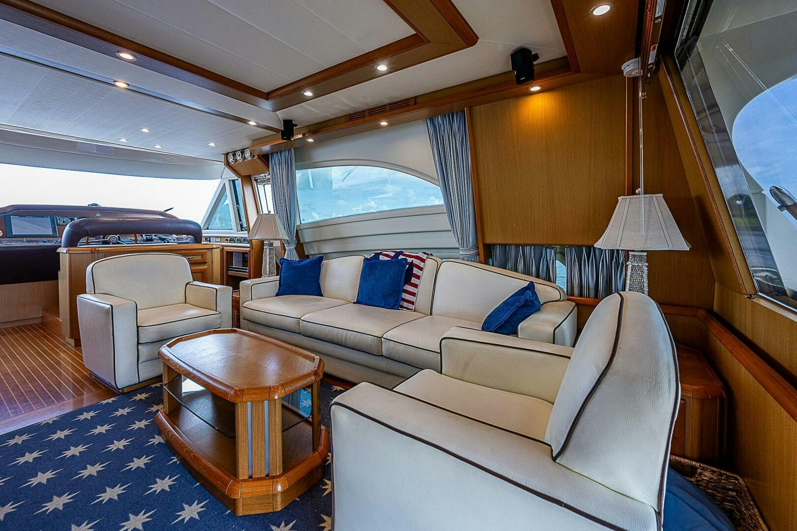 a living room with a large blue rug and a large window aboard KNOT NANNY'S Yacht for Sale