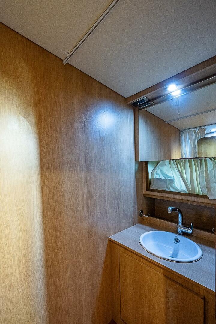 a bathroom with a sink and a mirror aboard KNOT NANNY'S Yacht for Sale