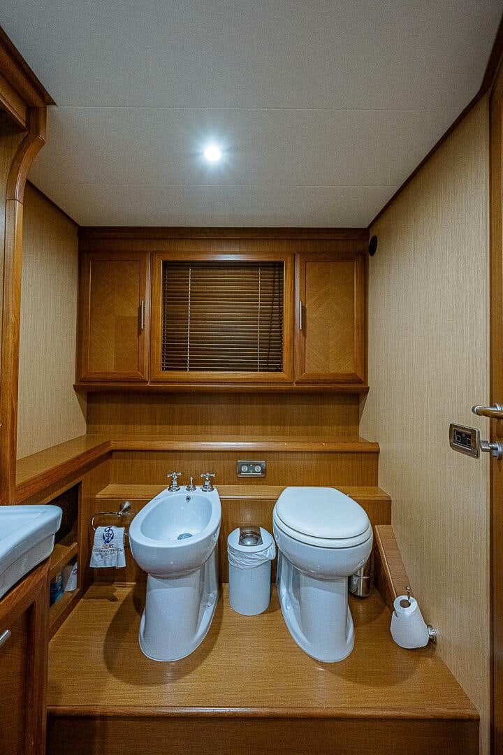 a bathroom with wooden cabinets aboard KNOT NANNY'S Yacht for Sale