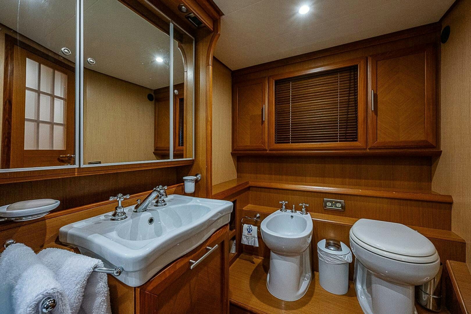 a bathroom with wooden cabinets aboard KNOT NANNY'S Yacht for Sale