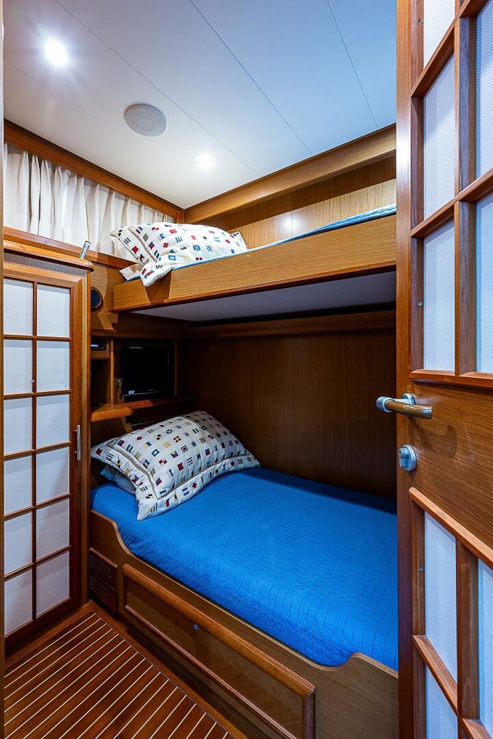 a bed with a blue sheet aboard KNOT NANNY'S Yacht for Sale
